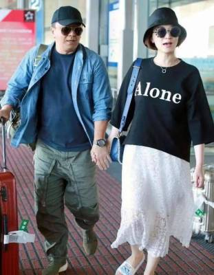 李小冉带着丈夫去了机场，她穿得时髦像个女孩子，老公穿得像她父母一样朴素